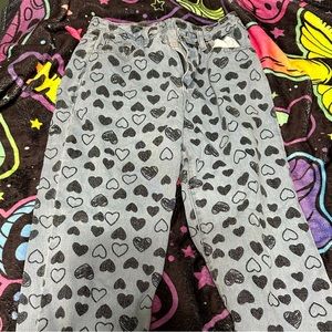 Light wash jeans with black hearts on them size 26